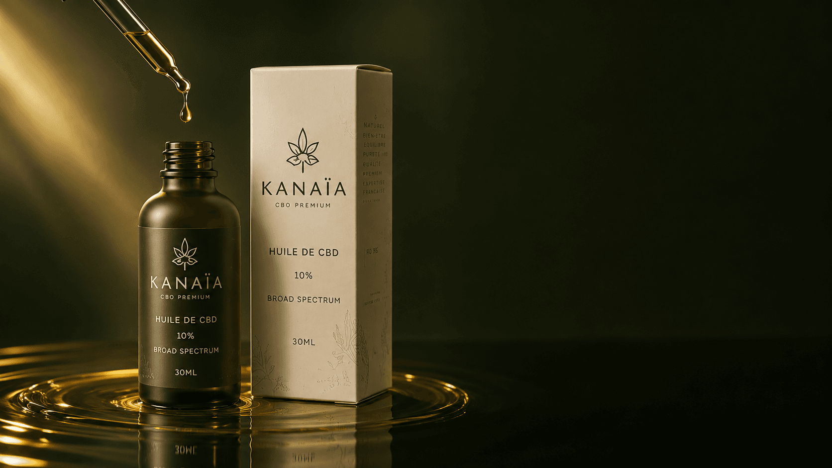Goutte d'huile de CBD tombant de la pipette au-dessus du flacon KANAÏA, reflets dorés sur fond sombre